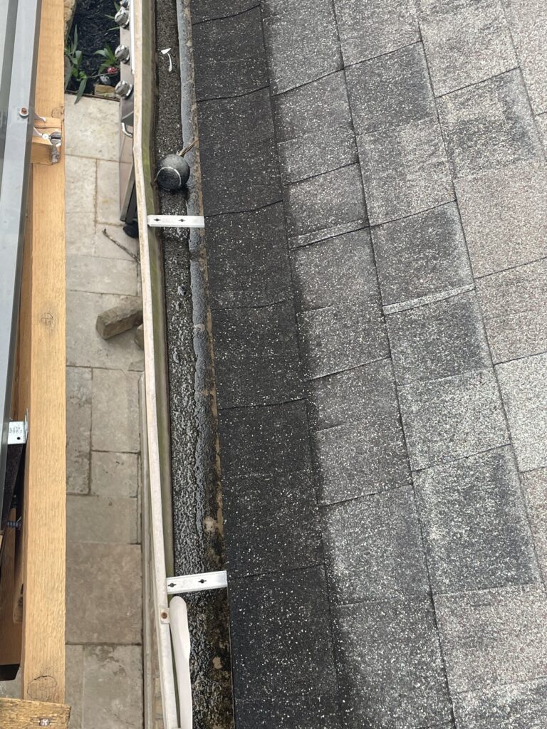 Roofer performing a roof certification inspection on a Katy TX home before closing