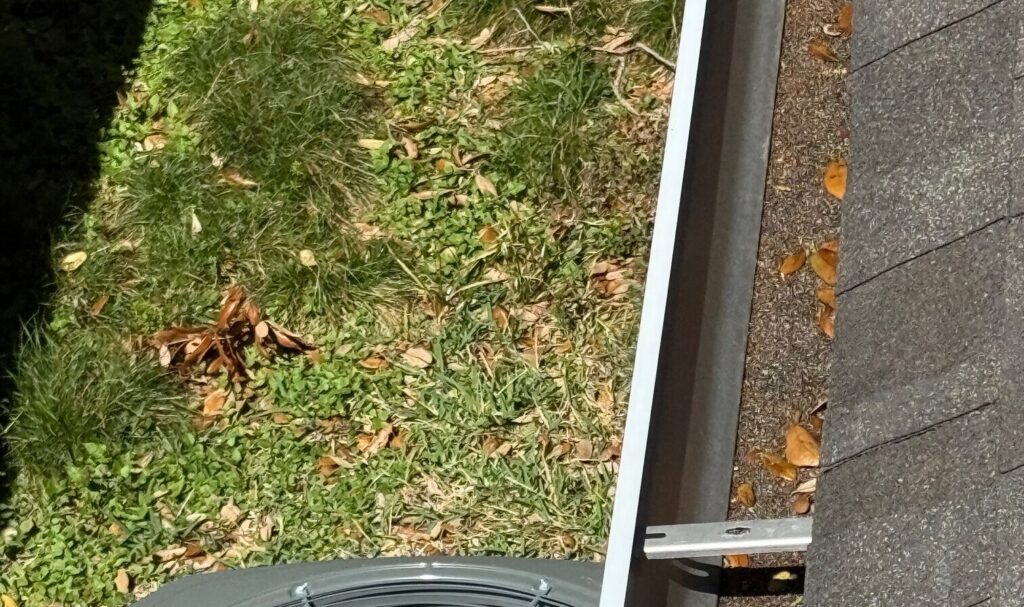 Cross-section of asphalt shingle layers showing roof damage